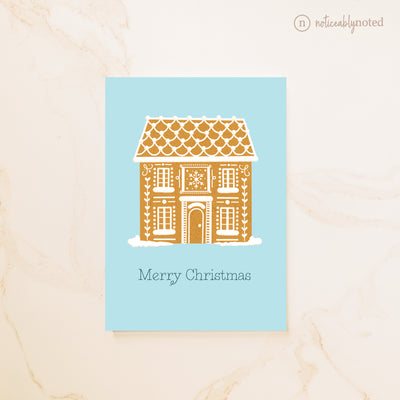 Gingerbread house design on a blue card with 'Merry Christmas' text, on a beige background.