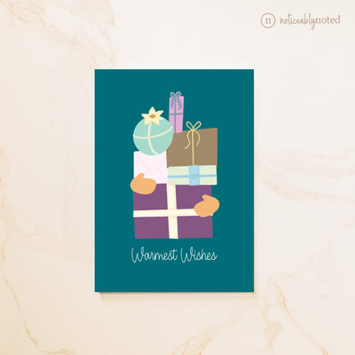 Greeting card with illustrations of wrapped gifts and 'Warmest Wishes' text on a teal background.