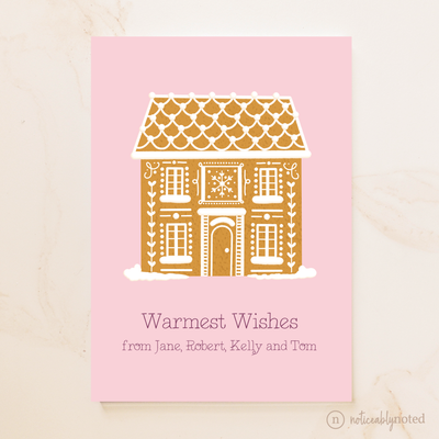 Greeting card with a gingerbread house design on a pink background