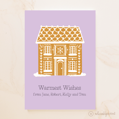 Greeting card with a gingerbread house illustration on a purple background