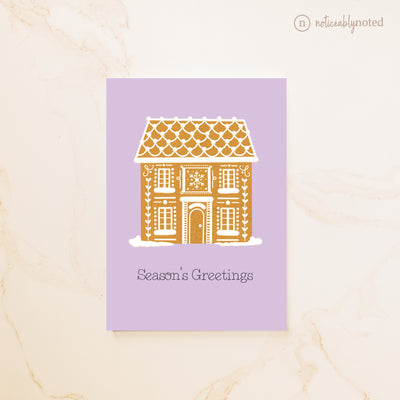 Greeting card with a gingerbread house design on a purple background