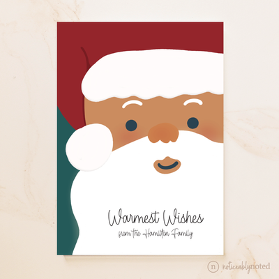 Illustration of a Santa Claus face with 'Warmest Wishes from the Hamilton Family' text on a beige background.
