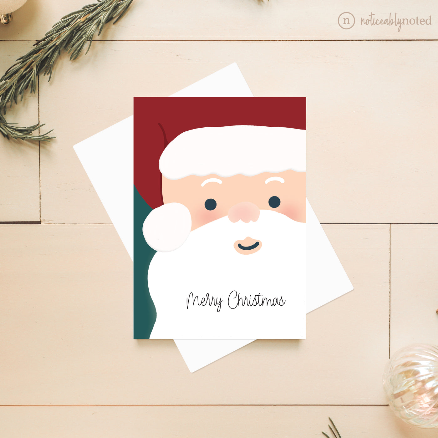Christmas card with Santa Claus illustration on a wooden surface