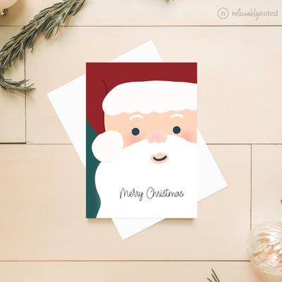 Christmas card with Santa Claus illustration on a wooden surface