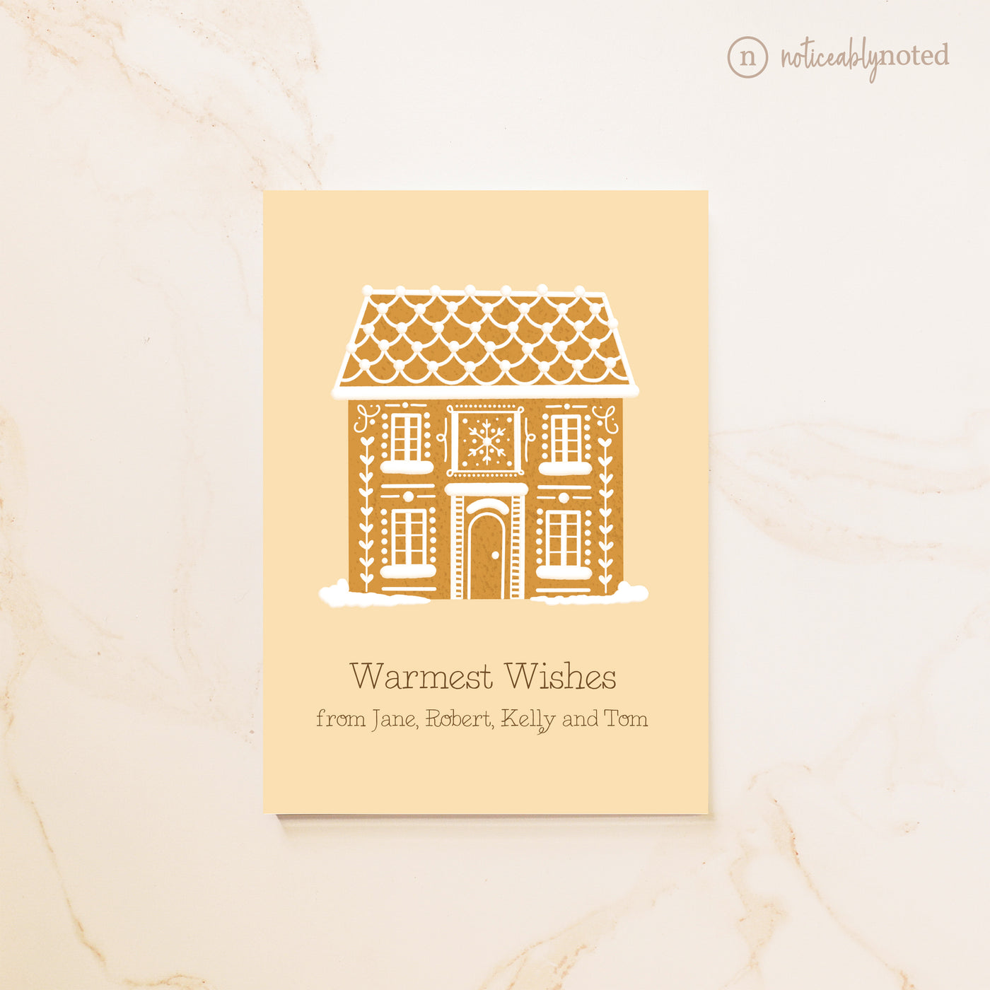 Greeting card with gingerbread house design on a beige background